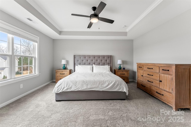 bedroom with light carpet, visible vents, a tray ceiling, and baseboards