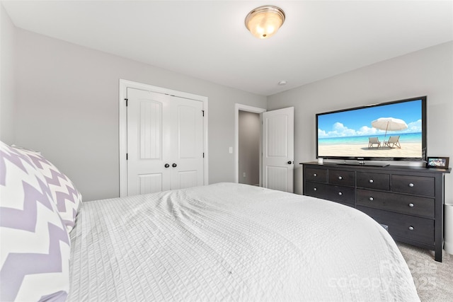 bedroom featuring light carpet and a closet