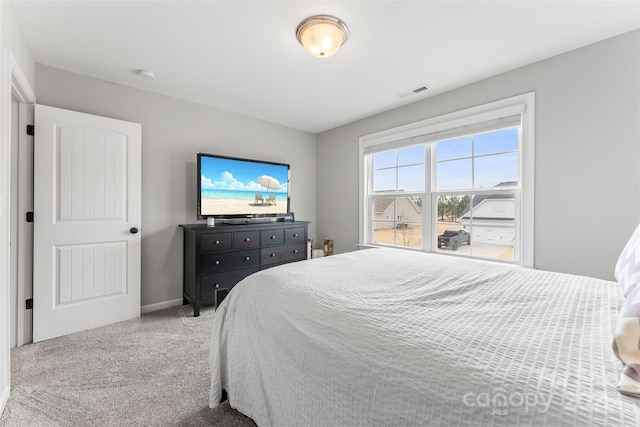 carpeted bedroom featuring baseboards and visible vents