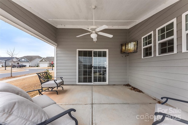 view of patio featuring a residential view and a ceiling fan