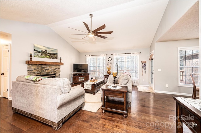 living room with lofted ceiling, a wealth of natural light, and dark hardwood / wood-style flooring