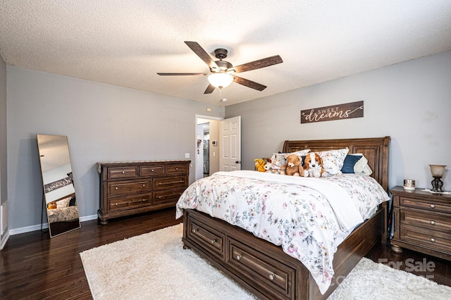 bedroom featuring ceiling fan, dark hardwood / wood-style floors, and a textured ceiling