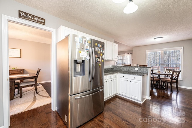 kitchen featuring white cabinetry, dark wood-type flooring, kitchen peninsula, and stainless steel fridge with ice dispenser