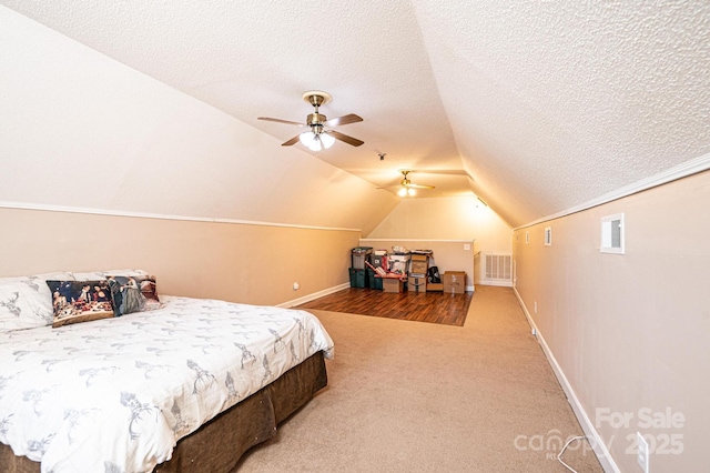 carpeted bedroom with ceiling fan, lofted ceiling, and a textured ceiling