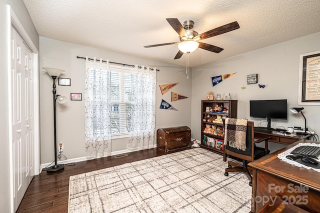 home office with hardwood / wood-style flooring, ceiling fan, and a textured ceiling