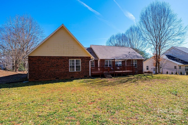 back of property with a wooden deck and a lawn