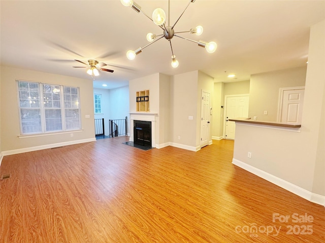 unfurnished living room with ceiling fan and light wood-type flooring