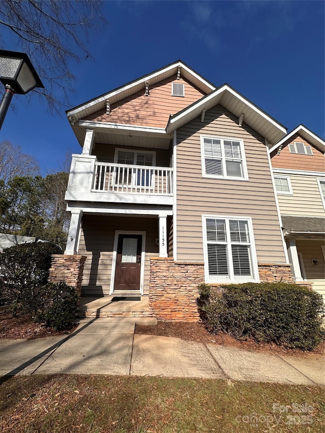 view of front of house featuring a balcony