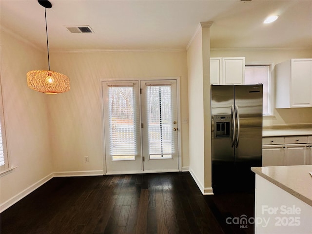 kitchen with white cabinetry, hanging light fixtures, dark wood-type flooring, and stainless steel fridge