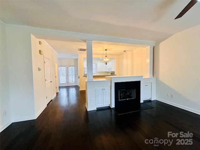 kitchen featuring french doors, dark hardwood / wood-style floors, pendant lighting, and kitchen peninsula