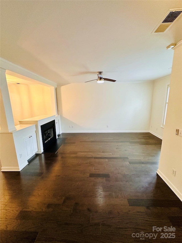 unfurnished living room with dark wood-type flooring and ceiling fan