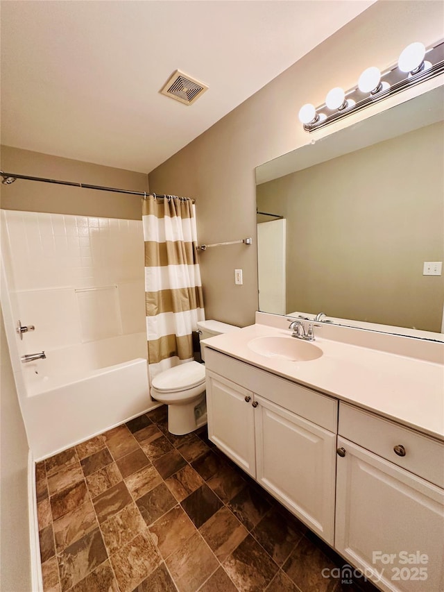 full bathroom featuring shower / bath combination with curtain, vanity, and toilet