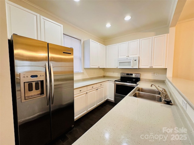 kitchen with white cabinetry, appliances with stainless steel finishes, crown molding, and sink