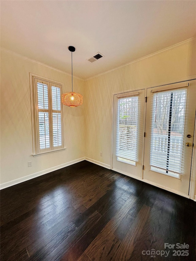 empty room with crown molding and dark hardwood / wood-style flooring