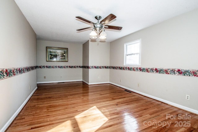 unfurnished room with ceiling fan and wood-type flooring