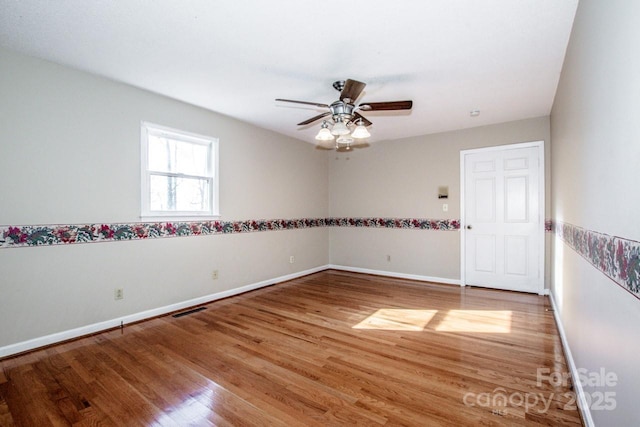 spare room featuring wood-type flooring and ceiling fan