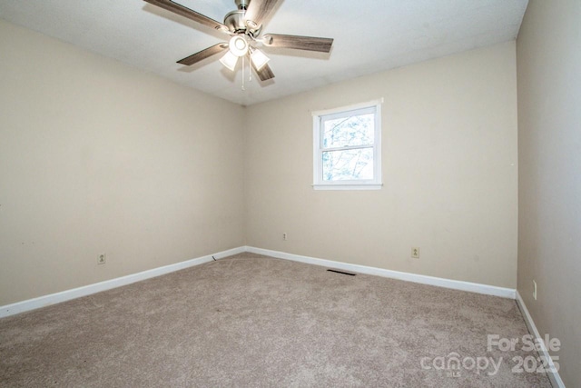 carpeted empty room with ceiling fan