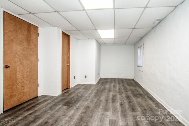 empty room with a paneled ceiling and hardwood / wood-style floors