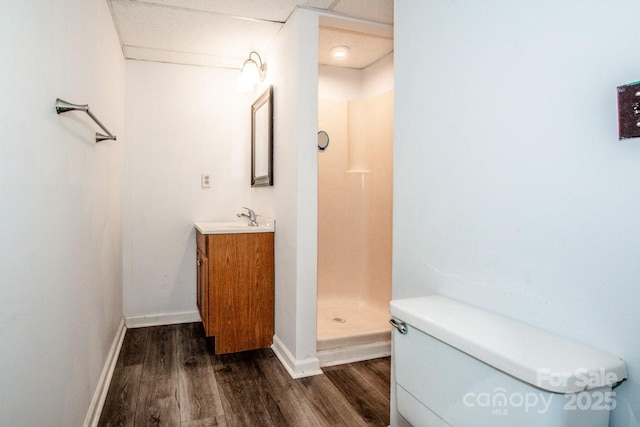 bathroom featuring walk in shower, vanity, toilet, and hardwood / wood-style floors