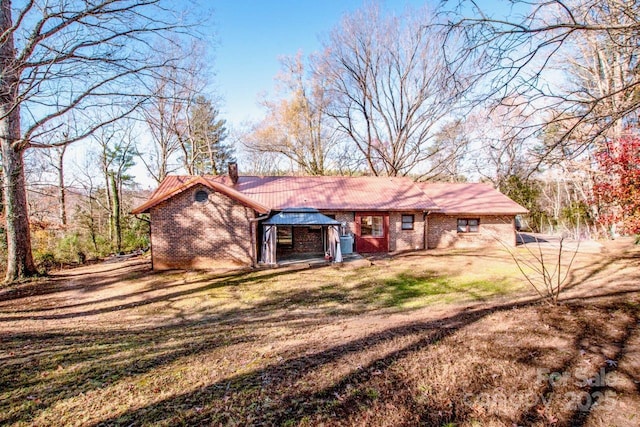 rear view of house featuring a yard and a gazebo