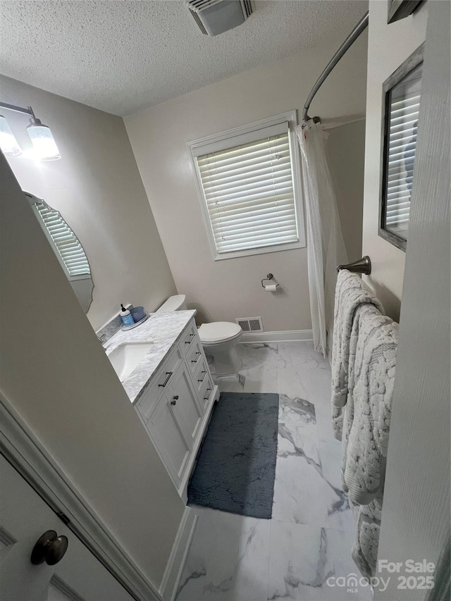 bathroom with vanity, a shower with shower curtain, a textured ceiling, and toilet