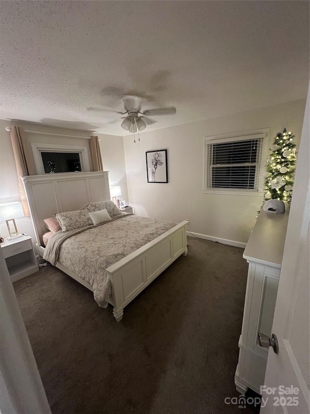 carpeted bedroom with ceiling fan and a textured ceiling