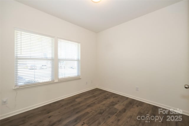 spare room featuring dark wood-type flooring