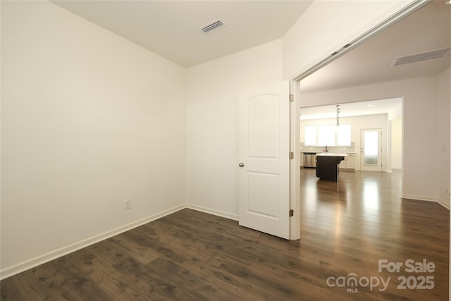 unfurnished room with sink and dark hardwood / wood-style floors