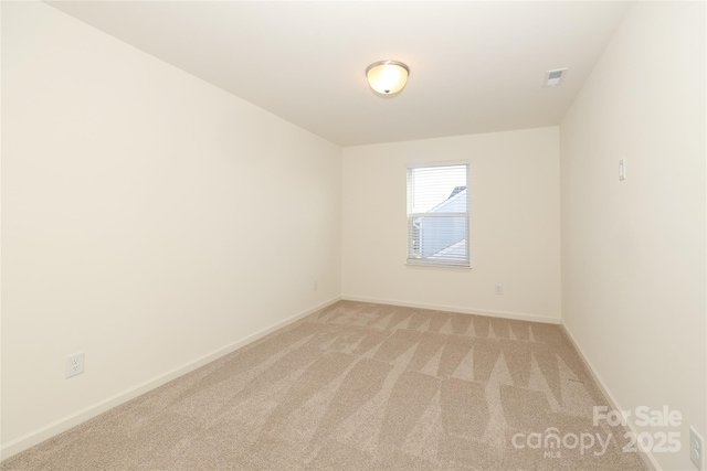 unfurnished room featuring light carpet