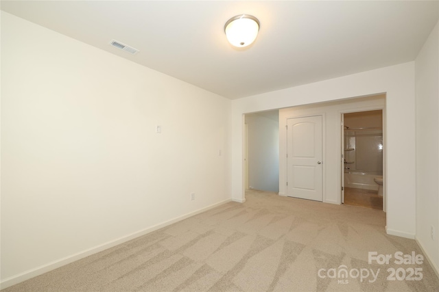 unfurnished room featuring light colored carpet