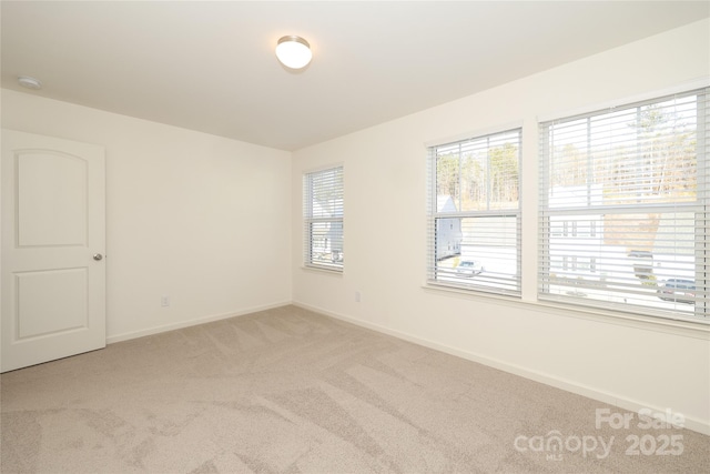 empty room featuring light colored carpet