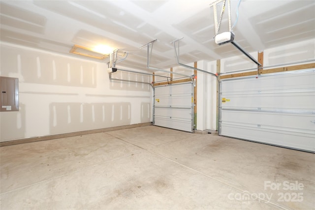 garage with a garage door opener and electric panel