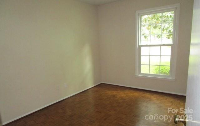 empty room featuring dark parquet floors