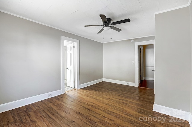 unfurnished room featuring ornamental molding, ceiling fan, dark wood-type flooring, and baseboards