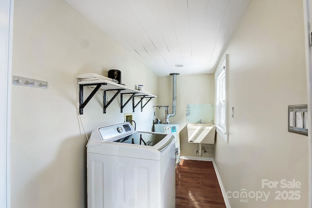 clothes washing area with laundry area, baseboards, dark wood-style floors, washer / clothes dryer, and water heater