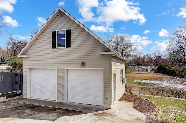 detached garage featuring fence