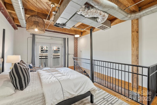 bedroom with hardwood / wood-style floors, access to outside, and wooden ceiling