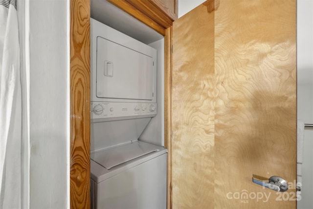 laundry room featuring stacked washer and clothes dryer