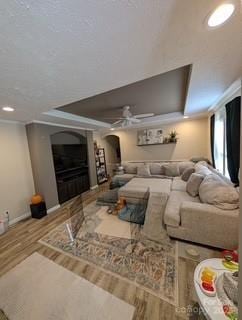 interior space with a tray ceiling and hardwood / wood-style floors