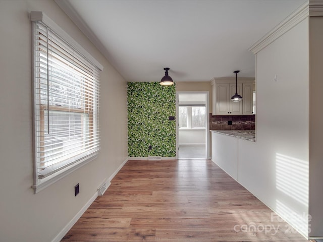 unfurnished dining area with light hardwood / wood-style floors