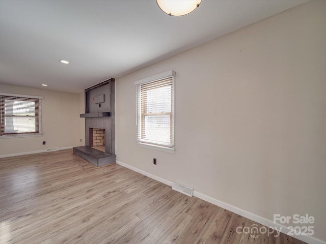 unfurnished living room with light hardwood / wood-style flooring