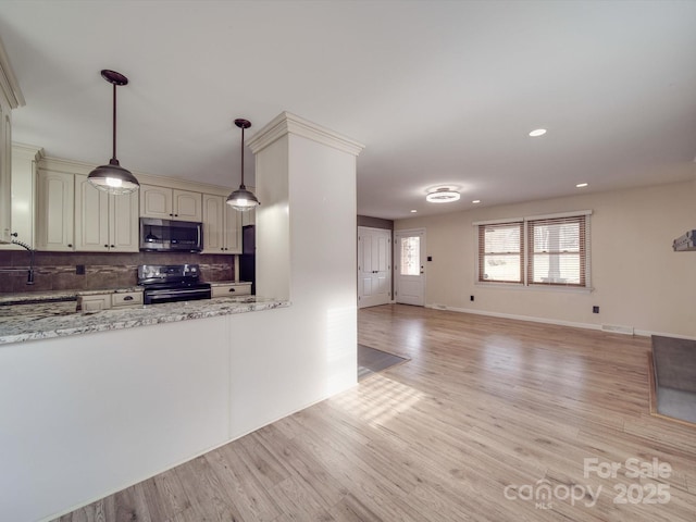 kitchen with backsplash, stainless steel appliances, light stone countertops, light hardwood / wood-style floors, and decorative light fixtures