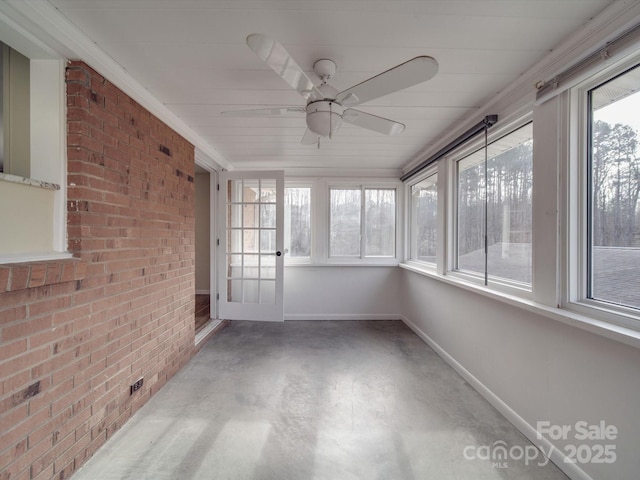 unfurnished sunroom with ceiling fan