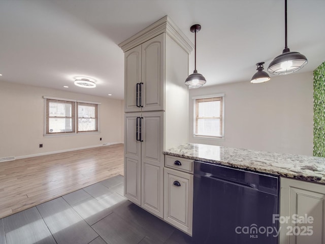 kitchen with black dishwasher, a wealth of natural light, and light stone counters