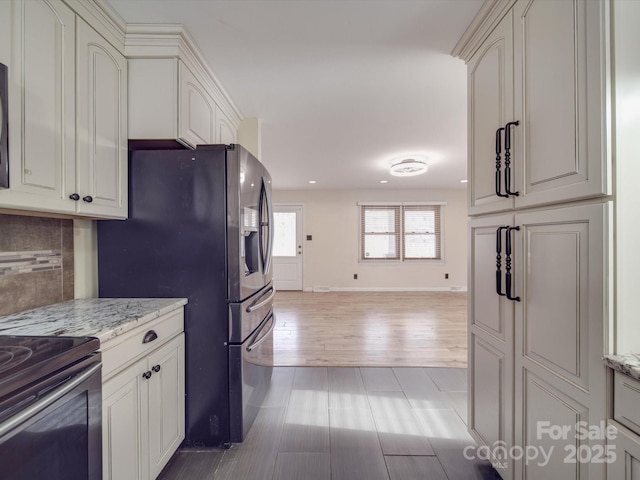 kitchen featuring light stone counters, decorative backsplash, wood-type flooring, and stainless steel appliances