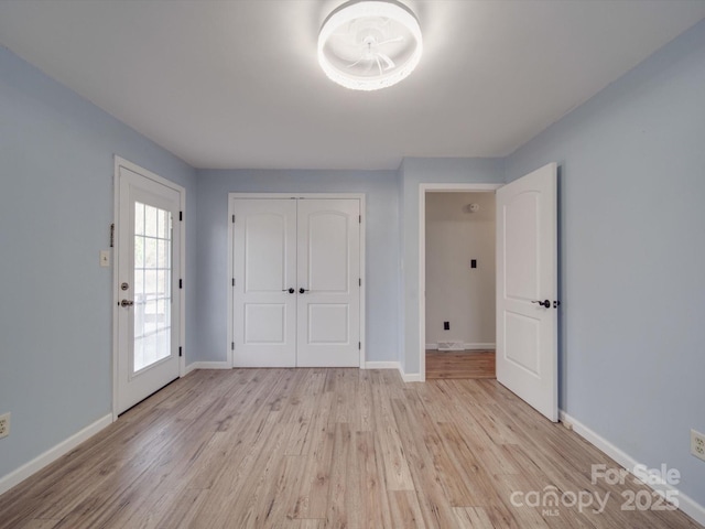 unfurnished bedroom featuring a closet and light wood-type flooring