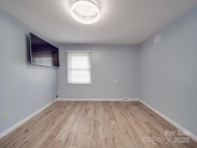 unfurnished room with light hardwood / wood-style floors