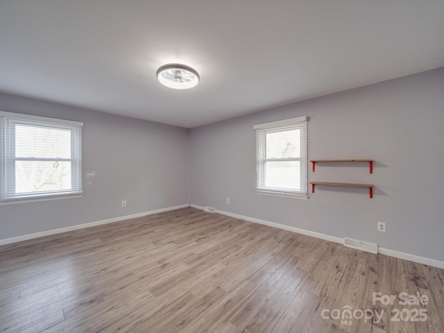 spare room with light wood-type flooring