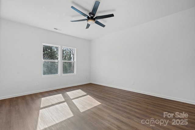 empty room featuring dark hardwood / wood-style floors and ceiling fan