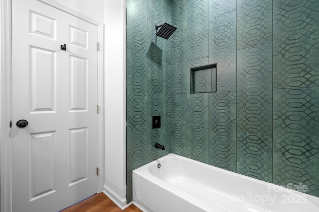 bathroom featuring hardwood / wood-style flooring and tiled shower / bath